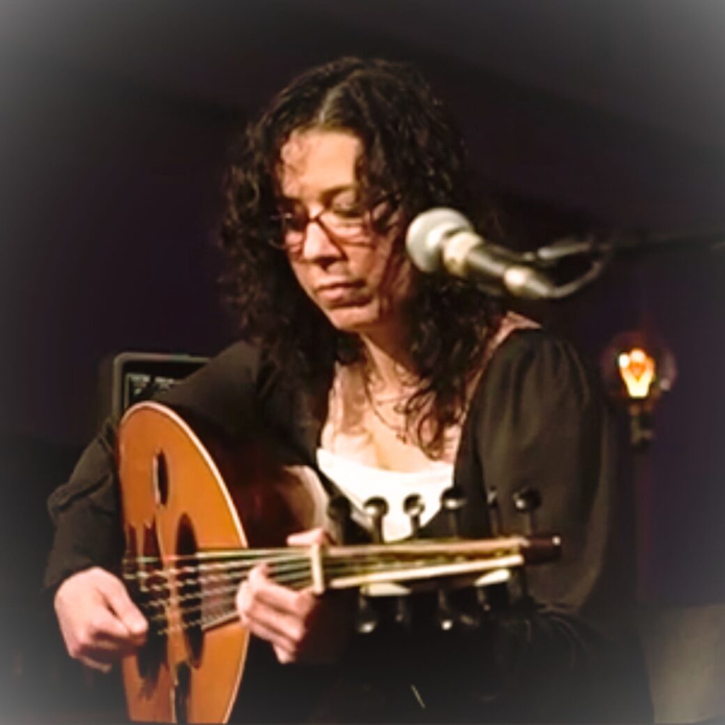 Ruba Hillawi performing on oud at a concert, London.
